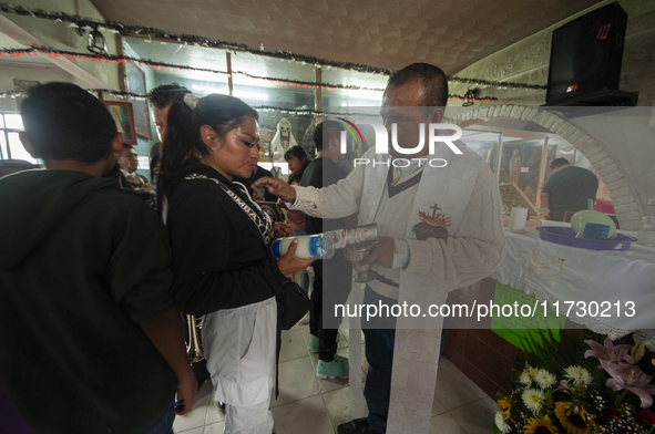 A faithful attends the temple of Santa Muerte in the municipality of Pedro Escobedo, Mexico, on November 1, 2024, to worship her and give th...