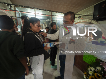 A faithful attends the temple of Santa Muerte in the municipality of Pedro Escobedo, Mexico, on November 1, 2024, to worship her and give th...