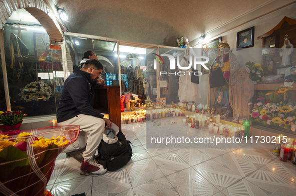 A faithful attends the temple of Santa Muerte in the municipality of Pedro Escobedo, Mexico, on November 1, 2024, to worship her and give th...