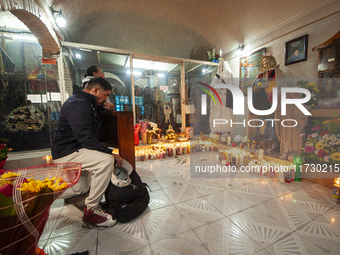 A faithful attends the temple of Santa Muerte in the municipality of Pedro Escobedo, Mexico, on November 1, 2024, to worship her and give th...