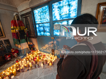 A faithful attends the temple of Santa Muerte in the municipality of Pedro Escobedo, Mexico, on November 1, 2024, to worship her and give th...