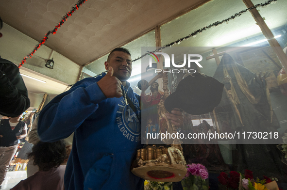 A faithful attends the temple of Santa Muerte in the municipality of Pedro Escobedo, Mexico, on November 1, 2024, to worship her and give th...