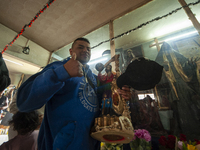 A faithful attends the temple of Santa Muerte in the municipality of Pedro Escobedo, Mexico, on November 1, 2024, to worship her and give th...