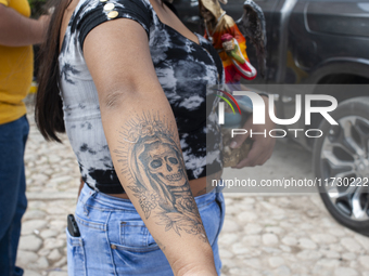 A faithful attends the temple of Santa Muerte in the municipality of Pedro Escobedo, Mexico, on November 1, 2024, to worship her and give th...