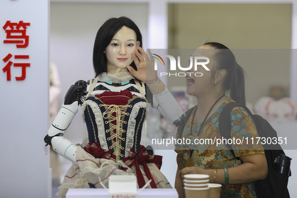 An audience speaks with an embodied robot in Xiamen, China, on November 1, 2024. 