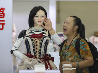 An audience speaks with an embodied robot in Xiamen, China, on November 1, 2024. (