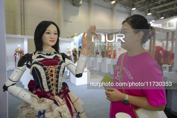 An audience speaks with an embodied robot in Xiamen, China, on November 1, 2024. 