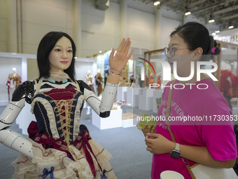 An audience speaks with an embodied robot in Xiamen, China, on November 1, 2024. (