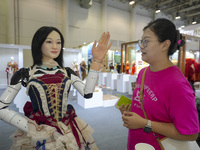 An audience speaks with an embodied robot in Xiamen, China, on November 1, 2024. (