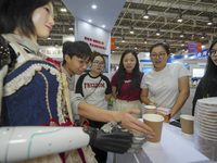 A staff member at Quanzhou Vocational College of Light Industry explains the intelligent skills and knowledge of an embodied robot deliverin...