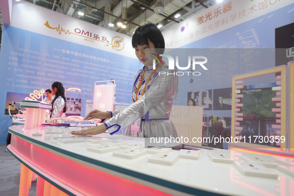 A staff member demonstrates a laser musical instrument on site in Xiamen, China, on November 1, 2024. 