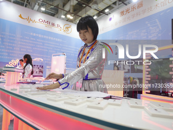 A staff member demonstrates a laser musical instrument on site in Xiamen, China, on November 1, 2024. (