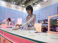 A staff member demonstrates a laser musical instrument on site in Xiamen, China, on November 1, 2024. (