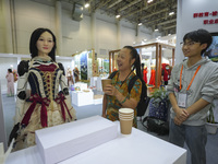 An audience speaks with an embodied robot in Xiamen, China, on November 1, 2024. (