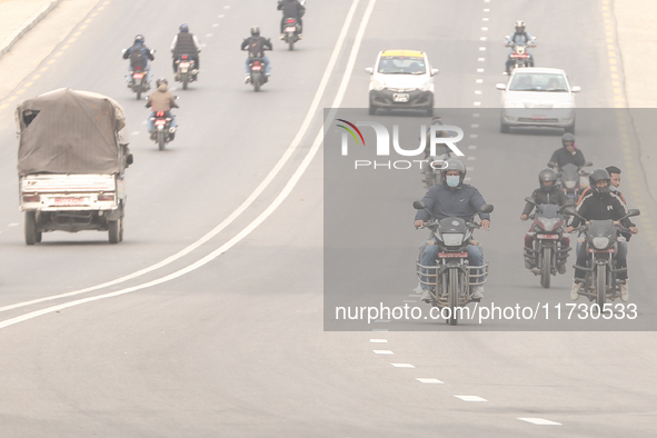 Nepalese people use face masks to protect themselves from air pollution on the roads of Kathmandu Valley in Kathmandu Valley, Nepal, on Nove...