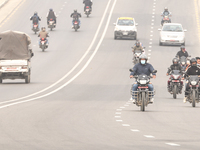 Nepalese people use face masks to protect themselves from air pollution on the roads of Kathmandu Valley in Kathmandu Valley, Nepal, on Nove...