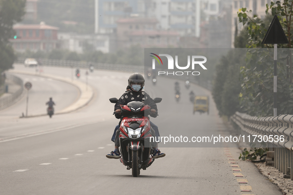 Nepalese people use face masks to protect themselves from air pollution on the roads of Kathmandu Valley in Kathmandu Valley, Nepal, on Nove...