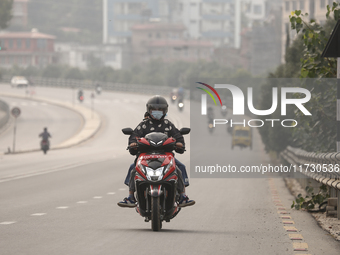 Nepalese people use face masks to protect themselves from air pollution on the roads of Kathmandu Valley in Kathmandu Valley, Nepal, on Nove...