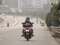 Nepalese people use face masks to protect themselves from air pollution on the roads of Kathmandu Valley in Kathmandu Valley, Nepal, on Nove...