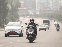 Nepalese people use face masks to protect themselves from air pollution on the roads of Kathmandu Valley in Kathmandu Valley, Nepal, on Nove...