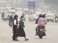 Nepalese people use face masks to protect themselves from air pollution on the roads of Kathmandu Valley in Kathmandu Valley, Nepal, on Nove...