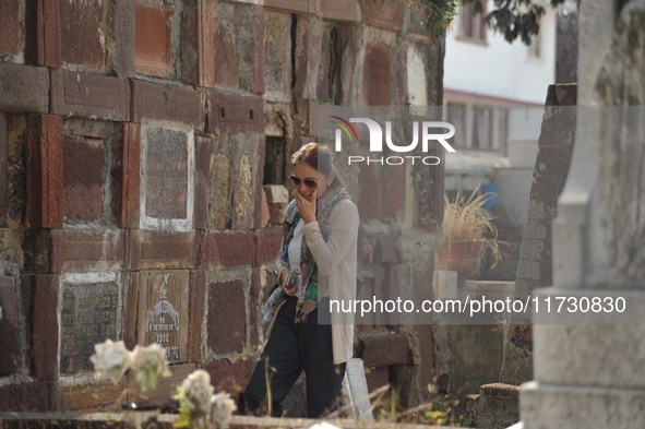 A person decorates the graves of her loved ones with cempasuchil flowers and holds a vigil at the Municipal Cemetery of Amealco de Bonfil. A...