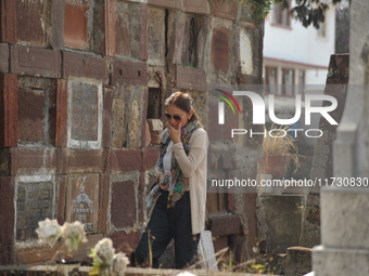 A person decorates the graves of her loved ones with cempasuchil flowers and holds a vigil at the Municipal Cemetery of Amealco de Bonfil. A...