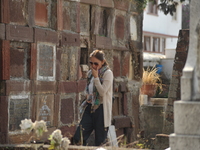 A person decorates the graves of her loved ones with cempasuchil flowers and holds a vigil at the Municipal Cemetery of Amealco de Bonfil. A...