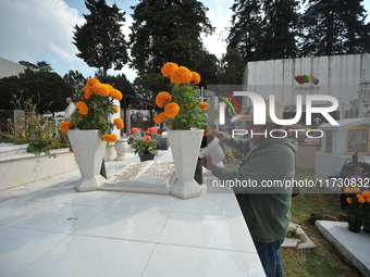 A person decorates the graves of his loved ones with cempasuchil flowers and holds a vigil at the Municipal Cemetery of Amealco de Bonfil. A...