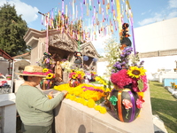 A person decorates the graves of her loved ones with cempasuchil flowers and holds a vigil at the Municipal Cemetery of Amealco de Bonfil. A...