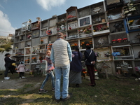 Relatives decorate the graves of their loved ones with cempasuchil flowers and hold a vigil at the Municipal Cemetery of Amealco de Bonfil....