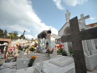 A person decorates the graves of his loved ones with cempasuchil flowers and holds a vigil at the Municipal Cemetery of Amealco de Bonfil. A...