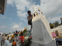 A person decorates the graves of his loved ones with cempasuchil flowers and holds a vigil at the Municipal Cemetery of Amealco de Bonfil. A...