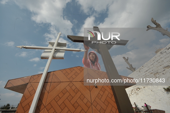 A person decorates the graves of her loved ones with cempasuchil flowers and holds a vigil at the Municipal Cemetery of Amealco de Bonfil. A...