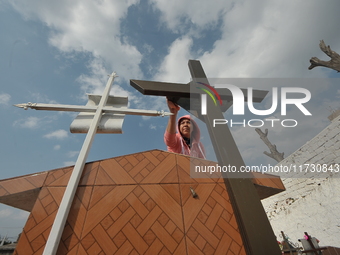 A person decorates the graves of her loved ones with cempasuchil flowers and holds a vigil at the Municipal Cemetery of Amealco de Bonfil. A...