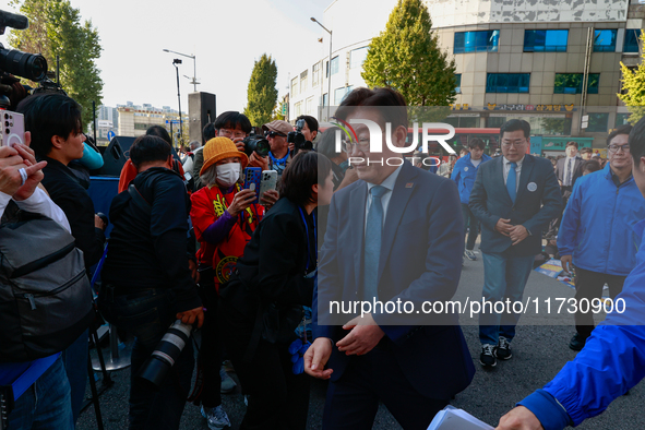 Lee Jae-myung, the leader of the Democratic Party, steps onto the stage to give a speech during a rally held in front of Seoul Station, call...