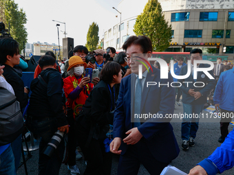 Lee Jae-myung, the leader of the Democratic Party, steps onto the stage to give a speech during a rally held in front of Seoul Station, call...