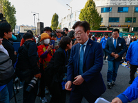 Lee Jae-myung, the leader of the Democratic Party, steps onto the stage to give a speech during a rally held in front of Seoul Station, call...