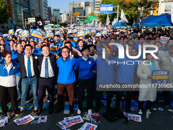 Democratic Party leader Lee Jae-myung (center), along with opposition lawmakers and tens of thousands of party members, holds a rally speech...