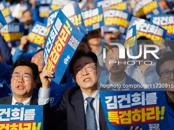 Democratic Party leader Lee Jae-myung (center), along with opposition lawmakers and tens of thousands of party members, holds a rally speech...