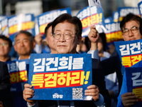 Democratic Party leader Lee Jae-myung (center), along with opposition lawmakers and tens of thousands of party members, holds a rally speech...