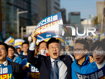 Democratic Party leader Lee Jae-myung (center), along with opposition lawmakers and tens of thousands of party members, holds a rally speech...