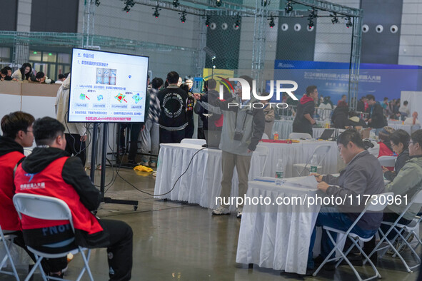 Visitors watch a robot perform at the China Robot Competition in Xi'an, China, on November 2, 2024. 