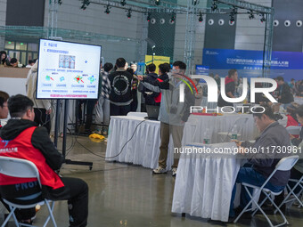 Visitors watch a robot perform at the China Robot Competition in Xi'an, China, on November 2, 2024. (