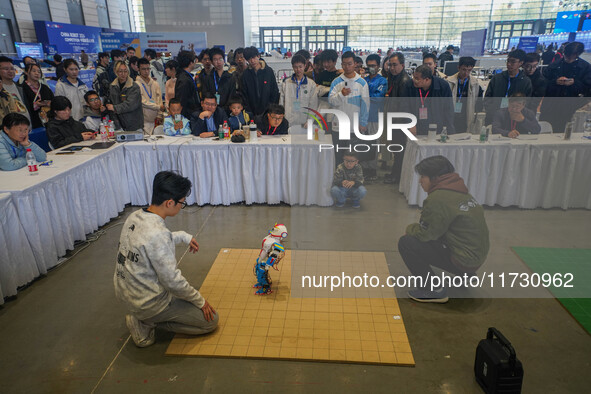 Visitors watch a robot perform at the China Robot Competition in Xi'an, China, on November 2, 2024. 