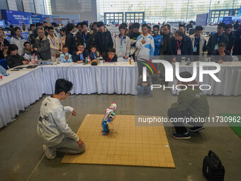 Visitors watch a robot perform at the China Robot Competition in Xi'an, China, on November 2, 2024. (