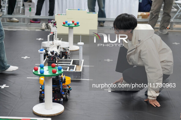 Visitors watch a robot perform at the China Robot Competition in Xi'an, China, on November 2, 2024. 