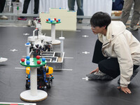 Visitors watch a robot perform at the China Robot Competition in Xi'an, China, on November 2, 2024. (