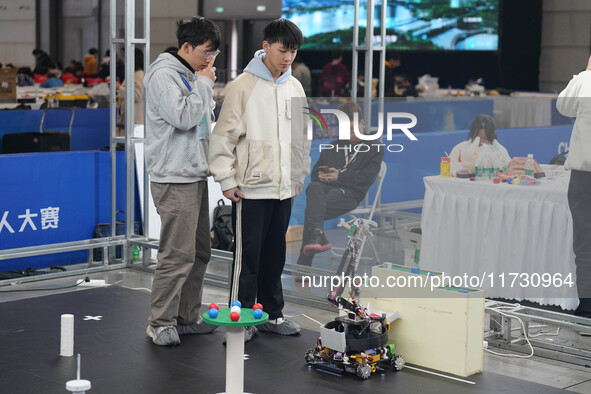 Visitors watch a robot perform at the China Robot Competition in Xi'an, China, on November 2, 2024. 