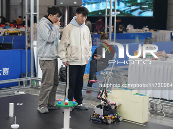 Visitors watch a robot perform at the China Robot Competition in Xi'an, China, on November 2, 2024. (